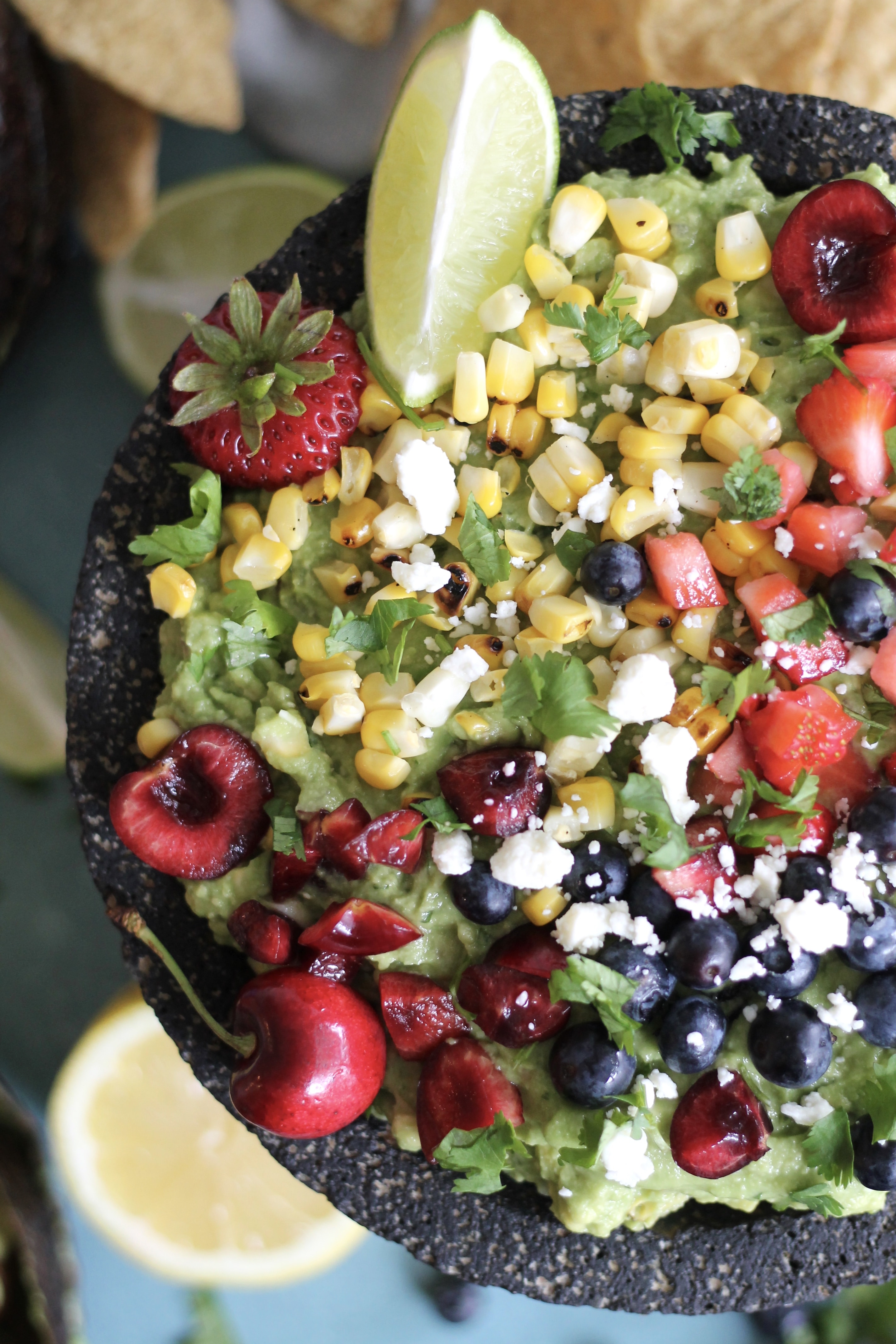 Loaded Summer Guacamole with Grilled Corn, Strawberries, Cherries