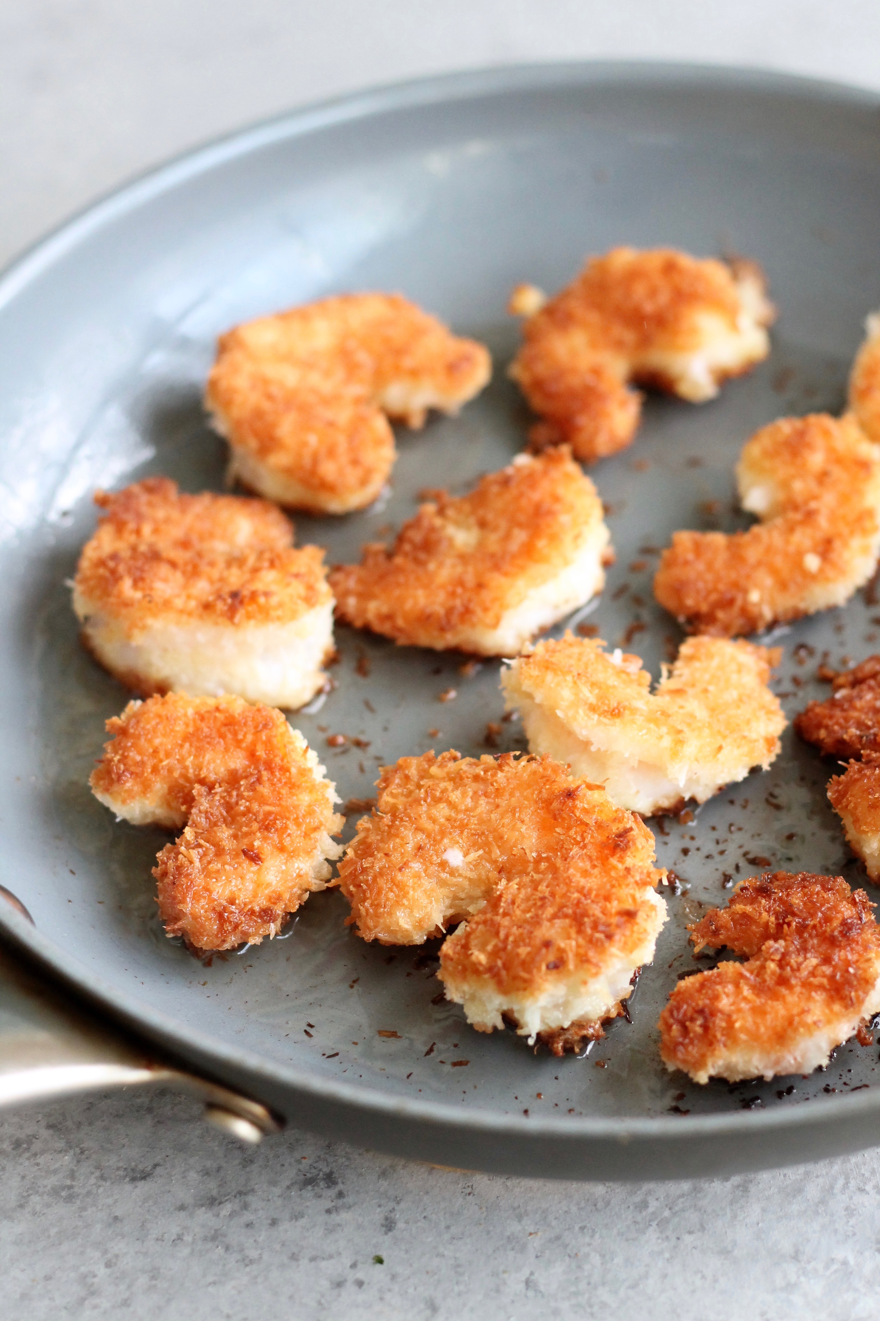 Closeup shot of coconut shrimp in a skillet