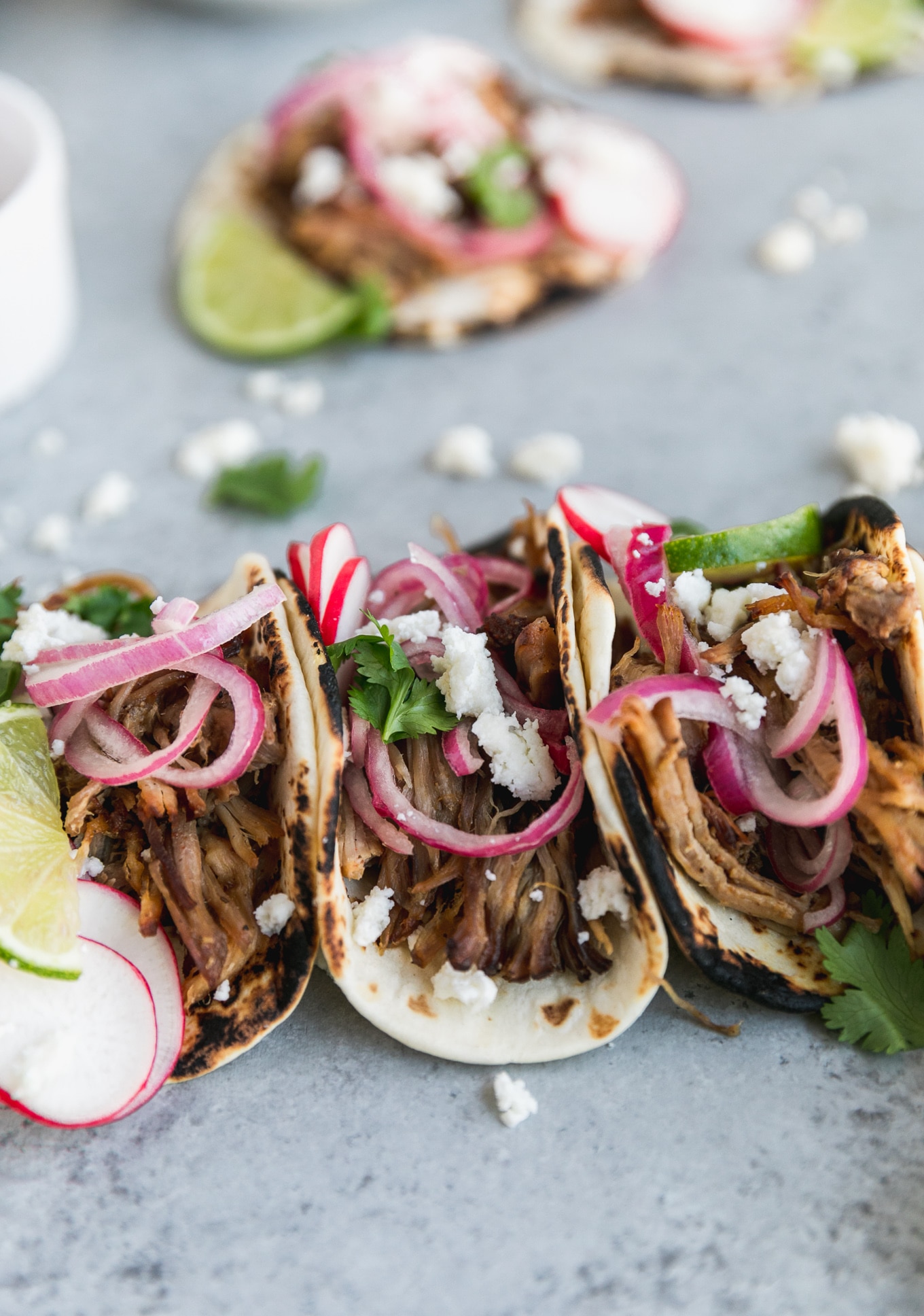 Slow Cooker Carnitas Street Tacos with Pickled Red Onions and Queso Fresco