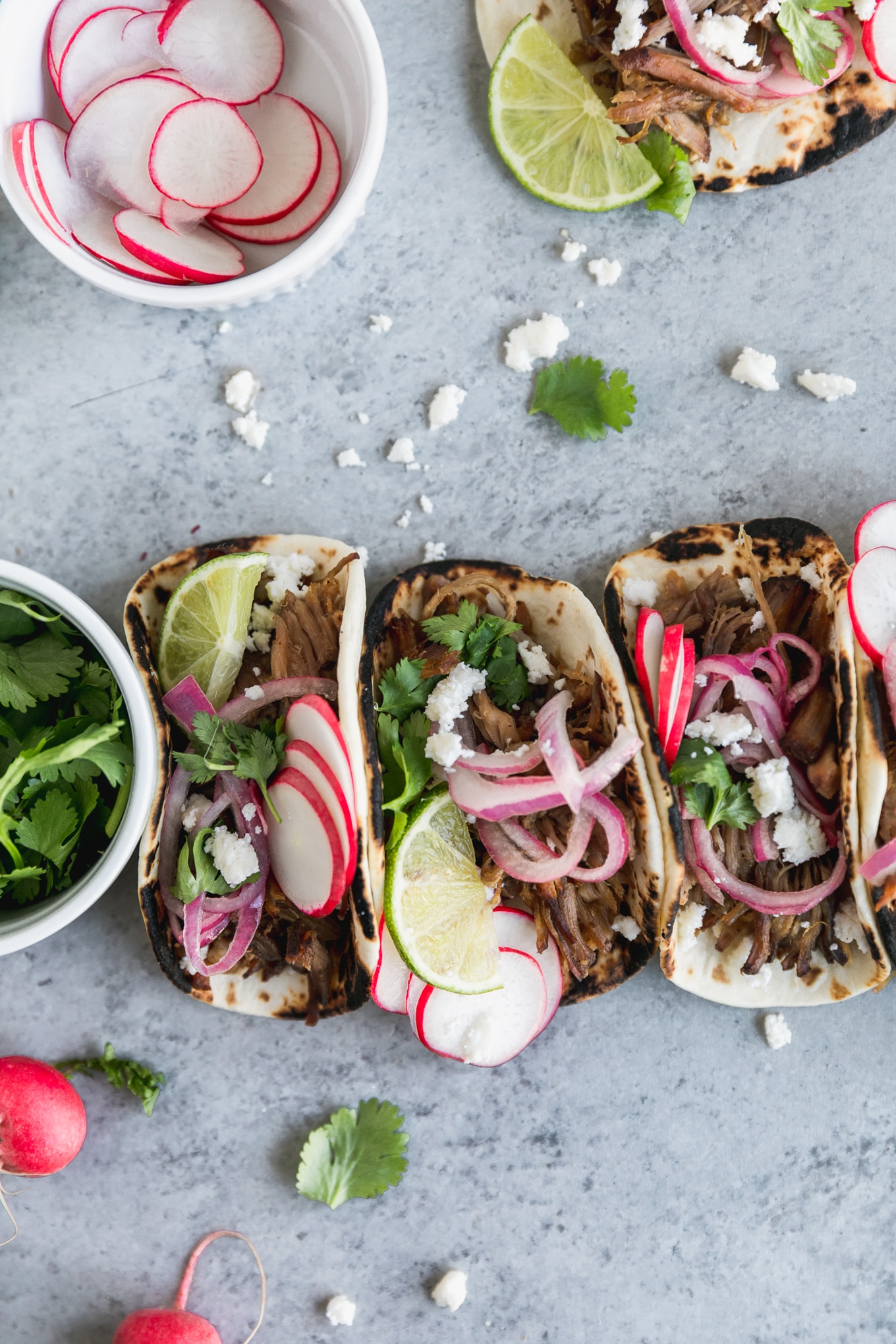 Slow Cooker Carnitas Street Tacos with Pickled Red Onions and Queso Fresco