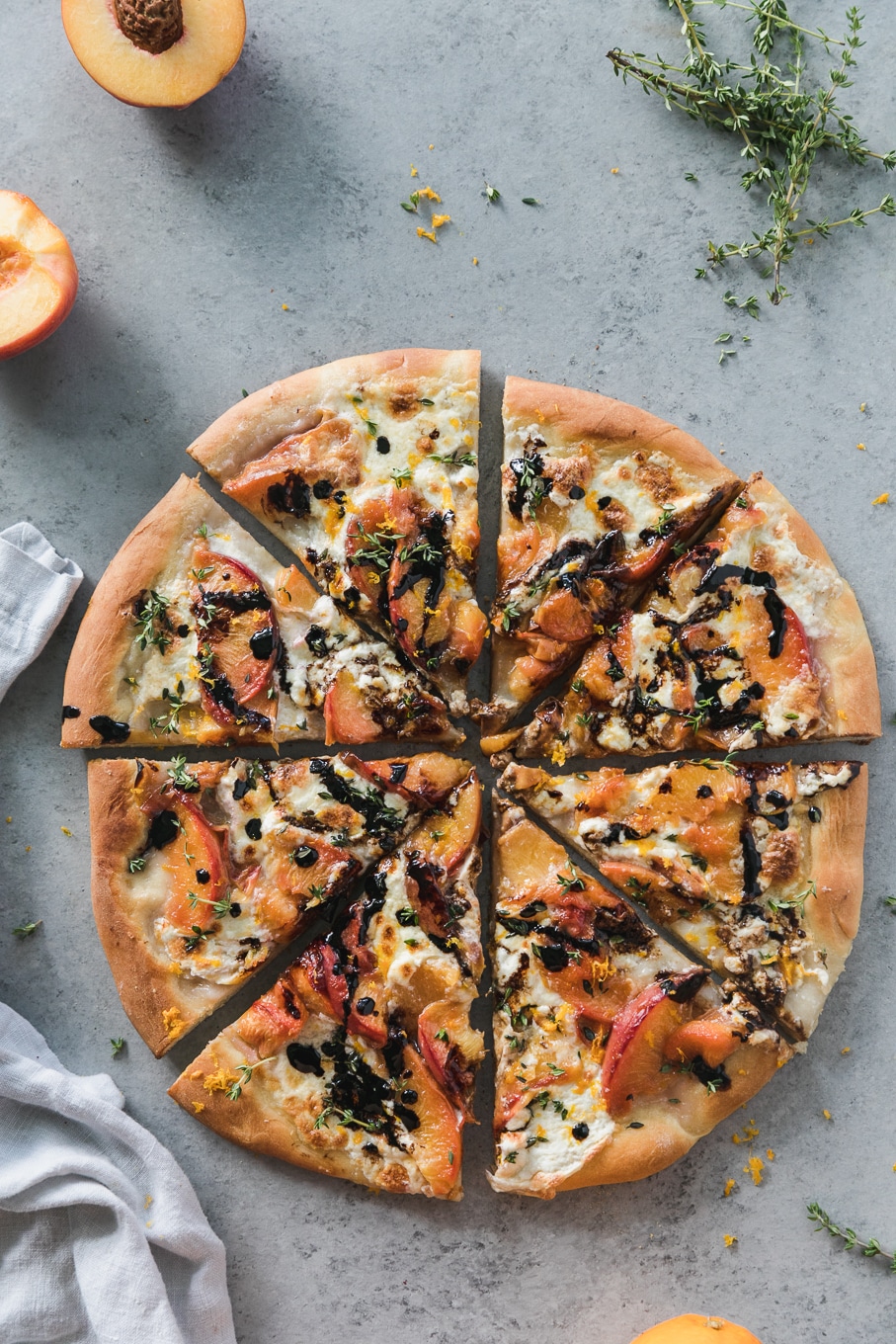 Overhead shot of a peach pizza cut into 8 slices