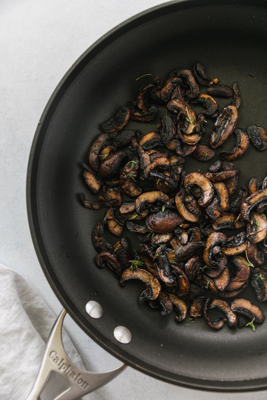 Overhead shot of a black skillet filled with crispy sautéed mushrooms