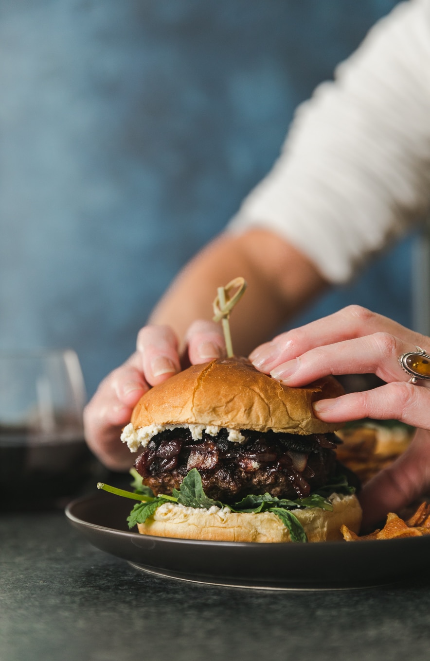 Close up shot of hands about to pick up a burger