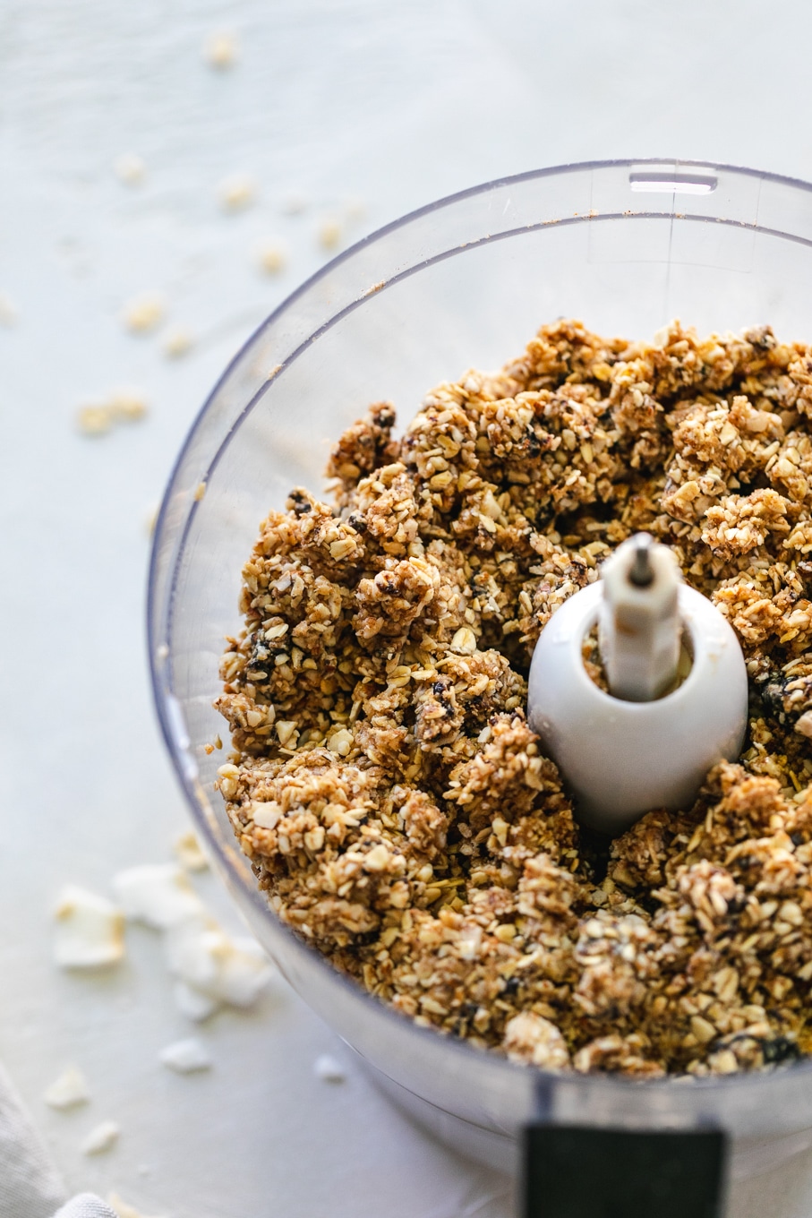 Close up shot of a food processor filled with oat almond mixture