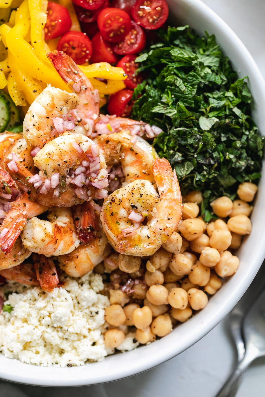 Overhead close up shot of a mediterranean chopped salad with shrimp