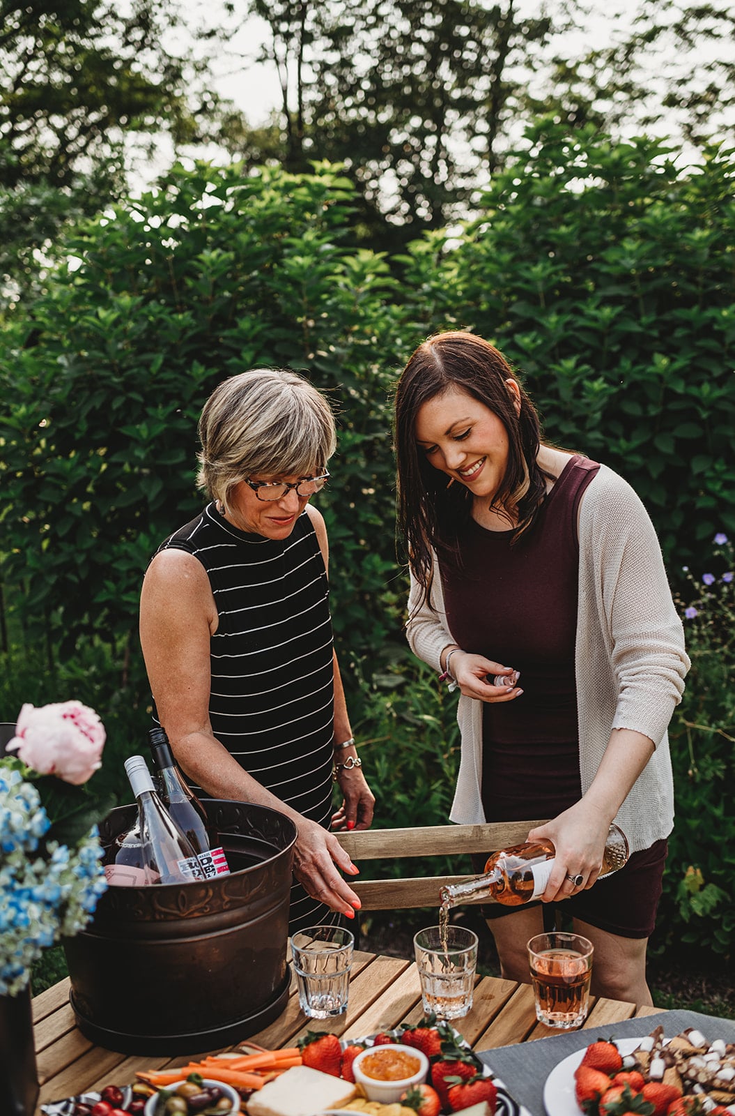 Shot of two women smiling and pouring a glass of wine