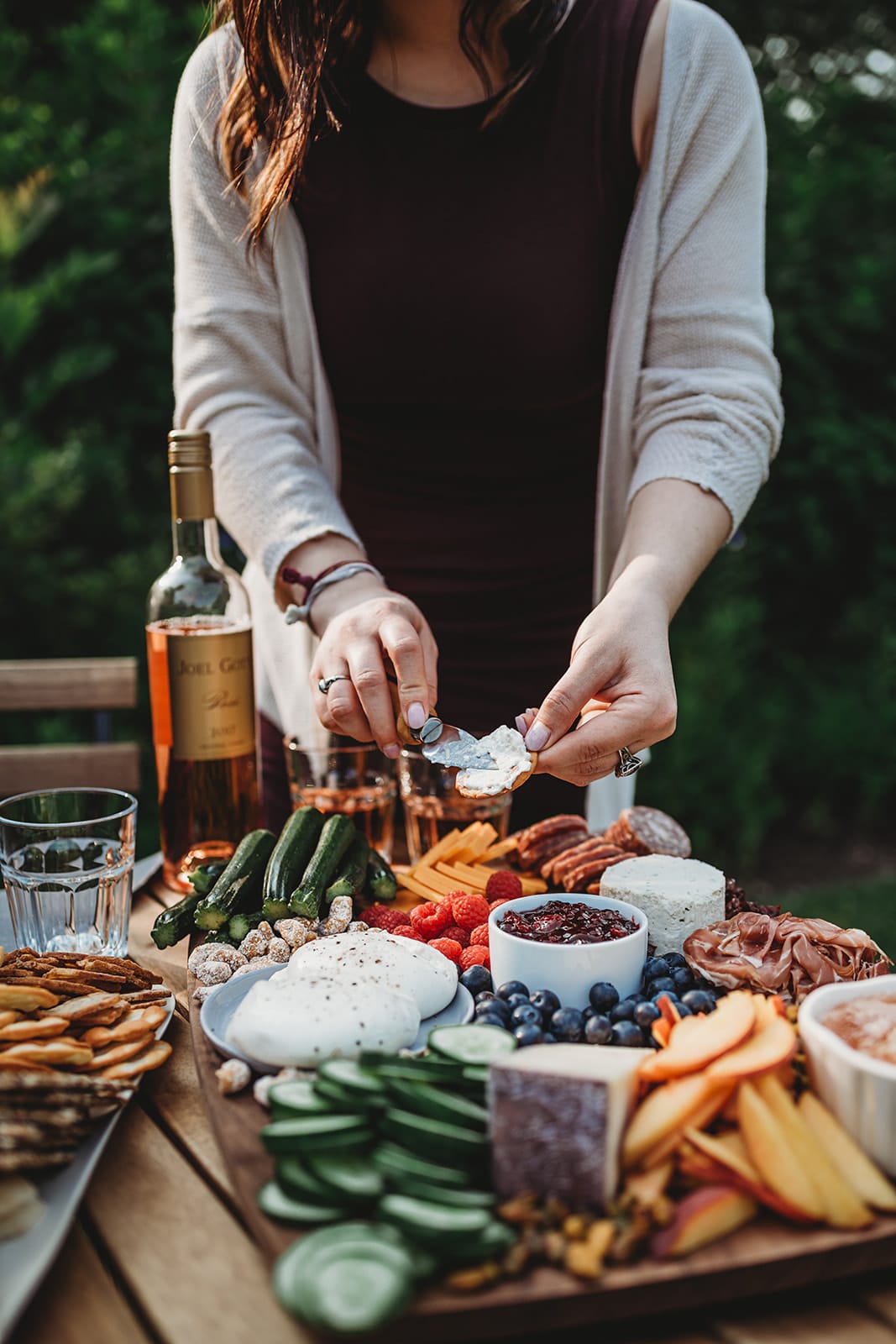 Shot of someone spreading cheese on a baguette