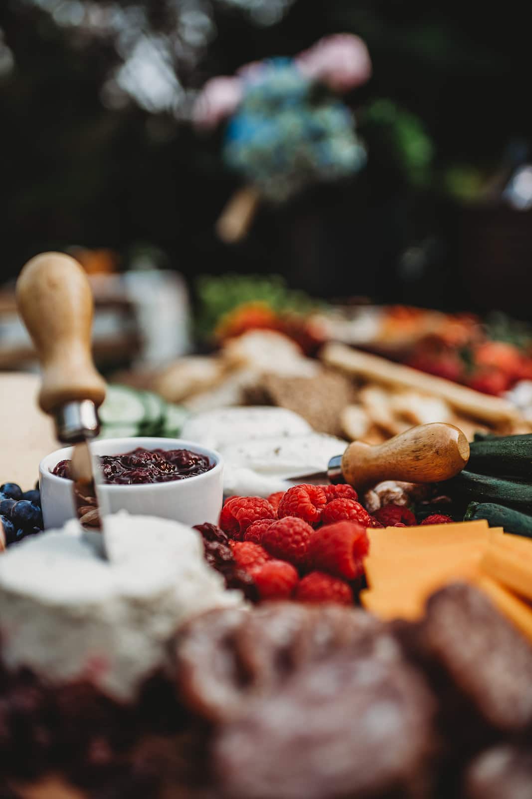 Close up shot of a colorful cheeseboard with raspberries