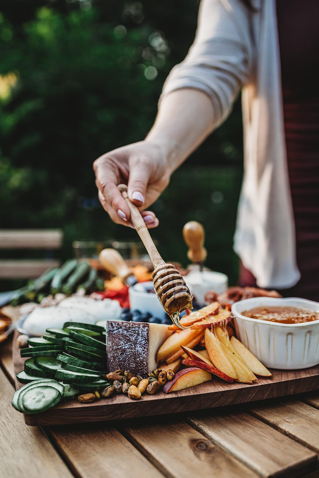 Shot of someone drizzling honey onto sliced peaches
