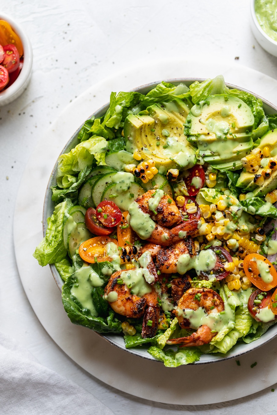 Overhead shot of a colorful blackened shrimp salad with avocado ranch