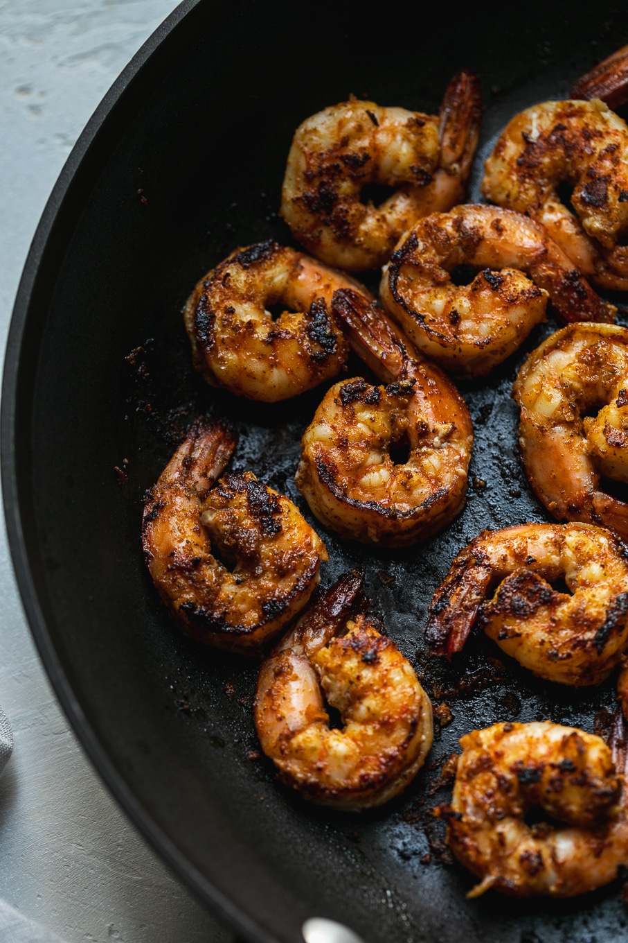 Close up shrimp of blackened shrimp in a black skillet