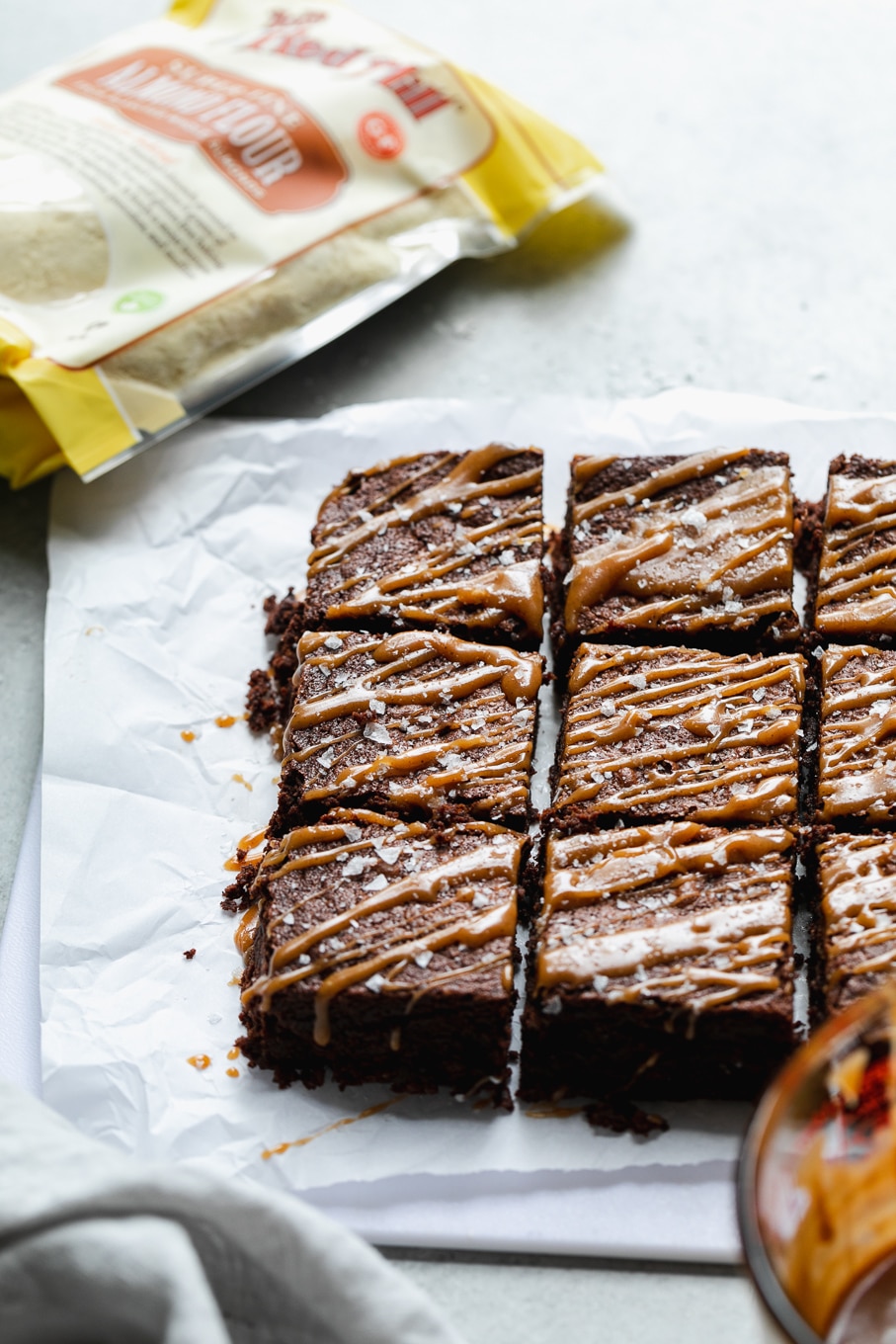45 degree angle shot of a batch of brownies with caramel drizzle