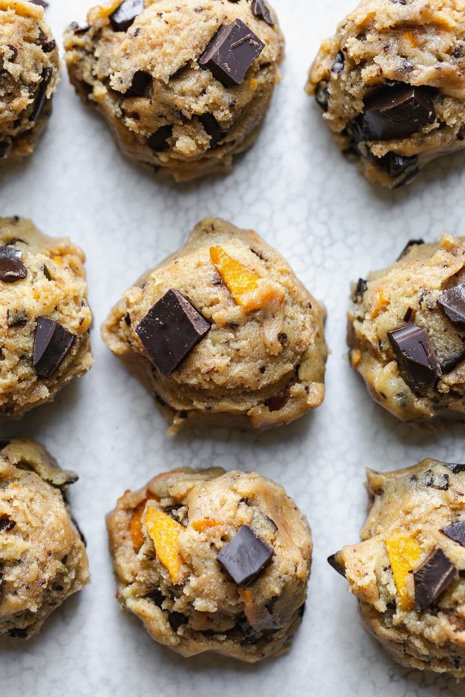 Overhead close up shot of cookie dough balls on a baking sheet