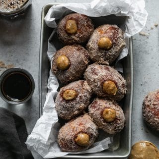 Overhead shot of dirty chai cream filled doughnuts in a loaf pan