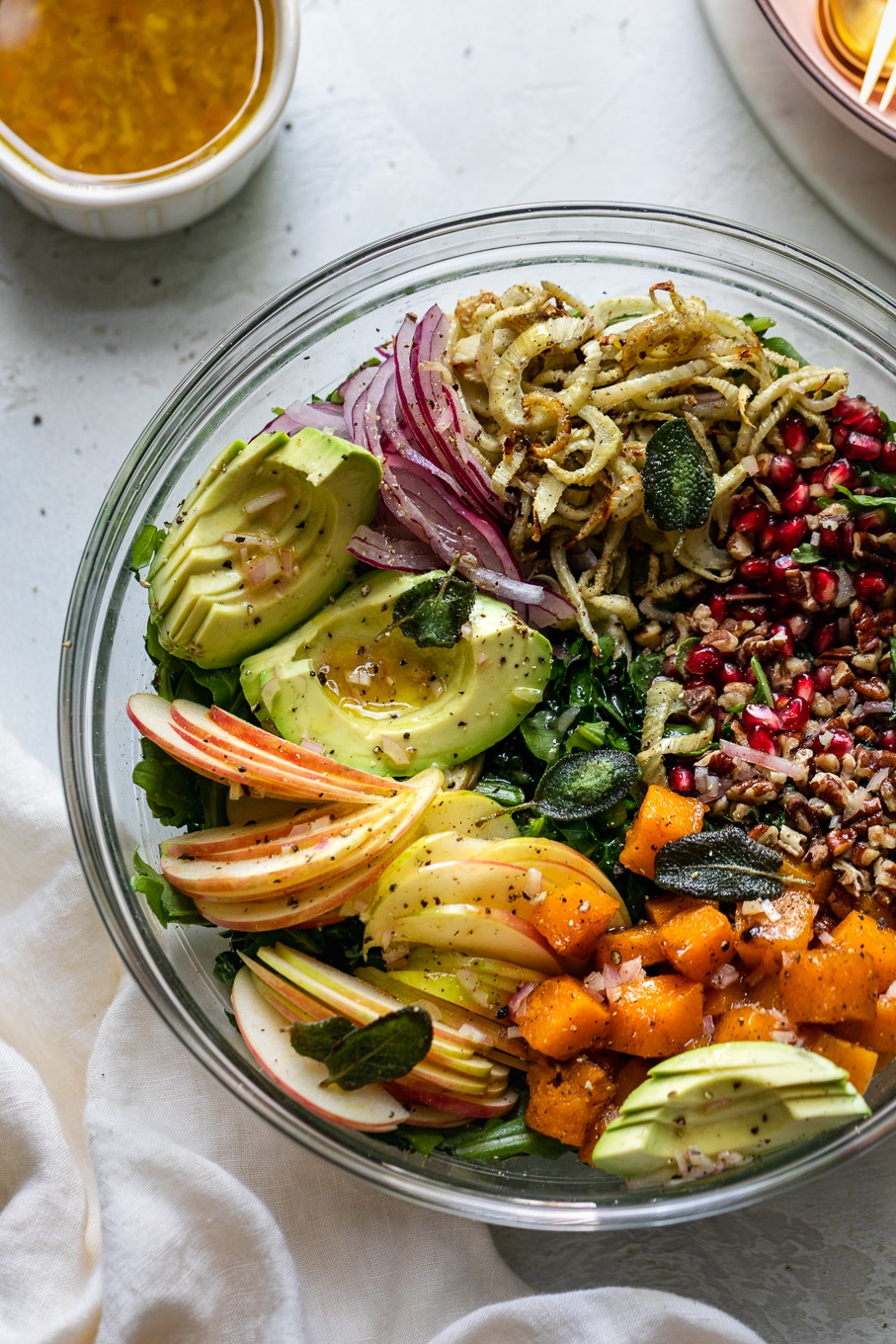 Overhead close up shot of a bowl filled with piles of colorful salad ingredients