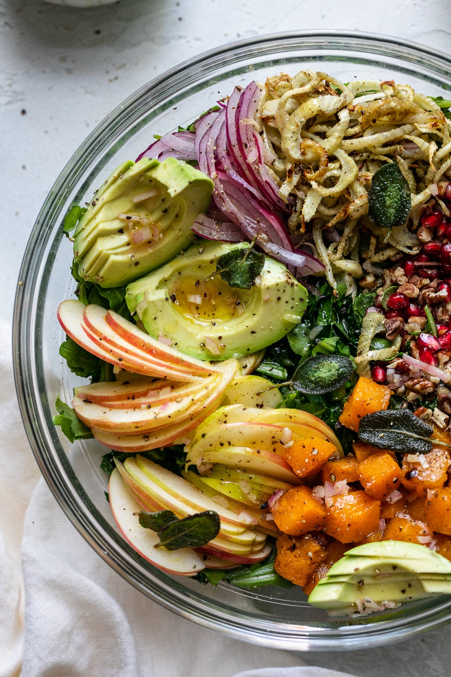 Overhead close up shot of a bowl filled with piles of colorful salad ingredients