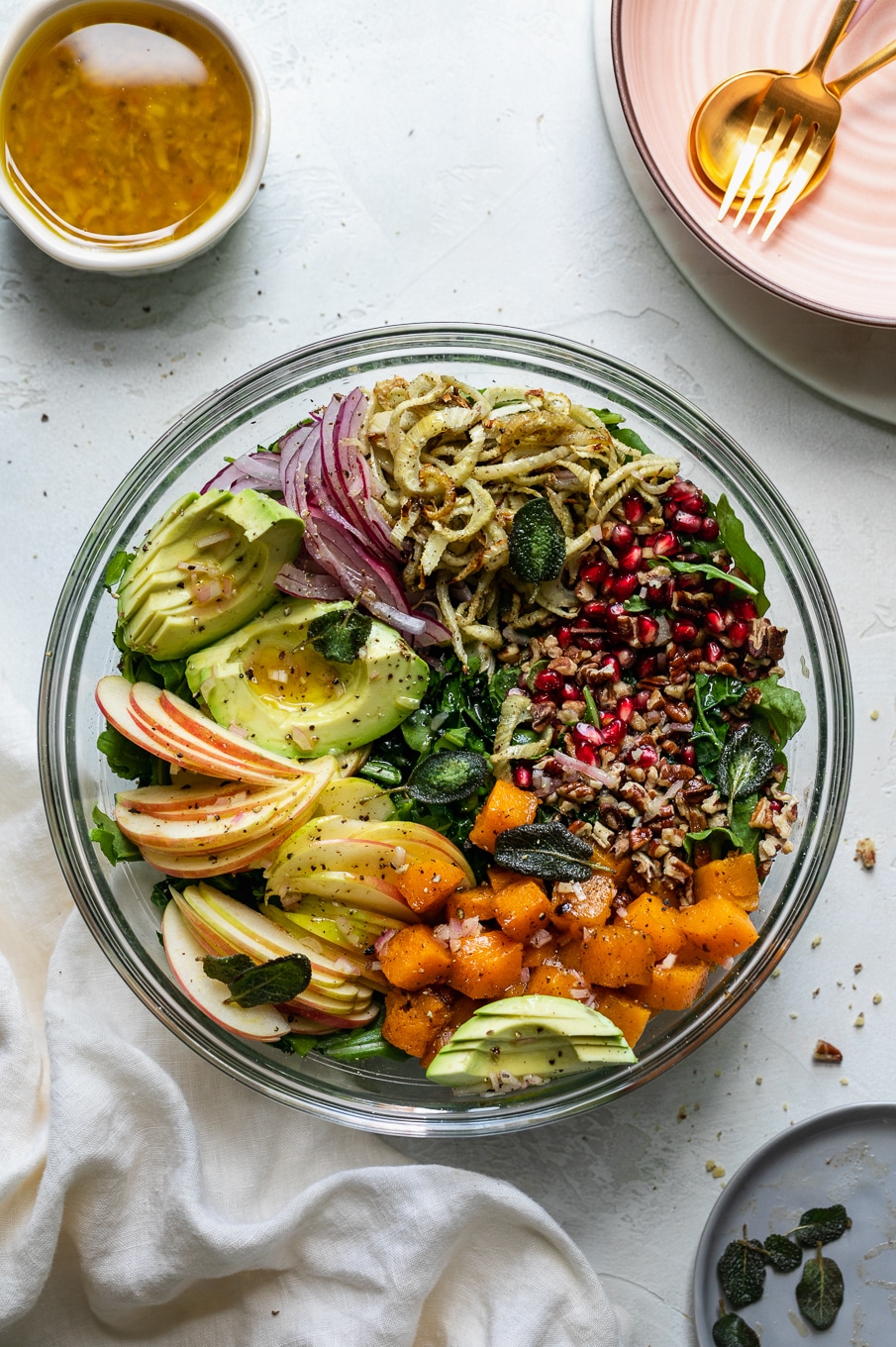 Overhead shot of a bowl filled with piles of colorful salad ingredients