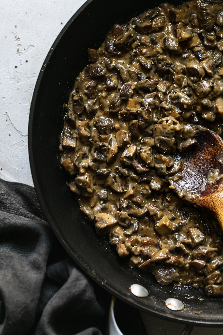 Overhead shot of a skillet filled with creamy vegan mushrooms