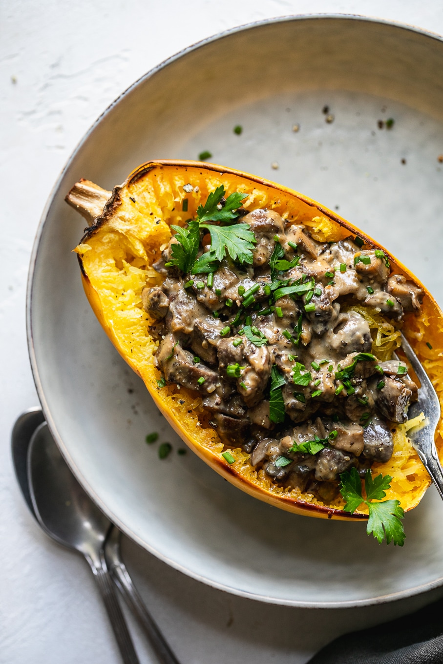 Overhead shot of a creamy mushroom spaghetti squash boat with a fork digging in