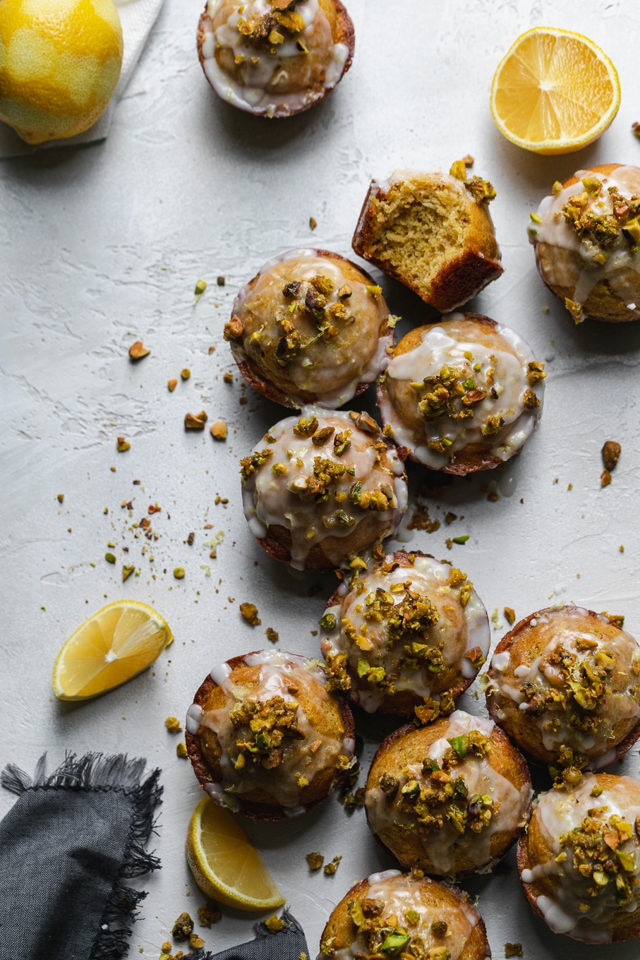 Overhead shot of lemon pistachio muffins arranged in a line