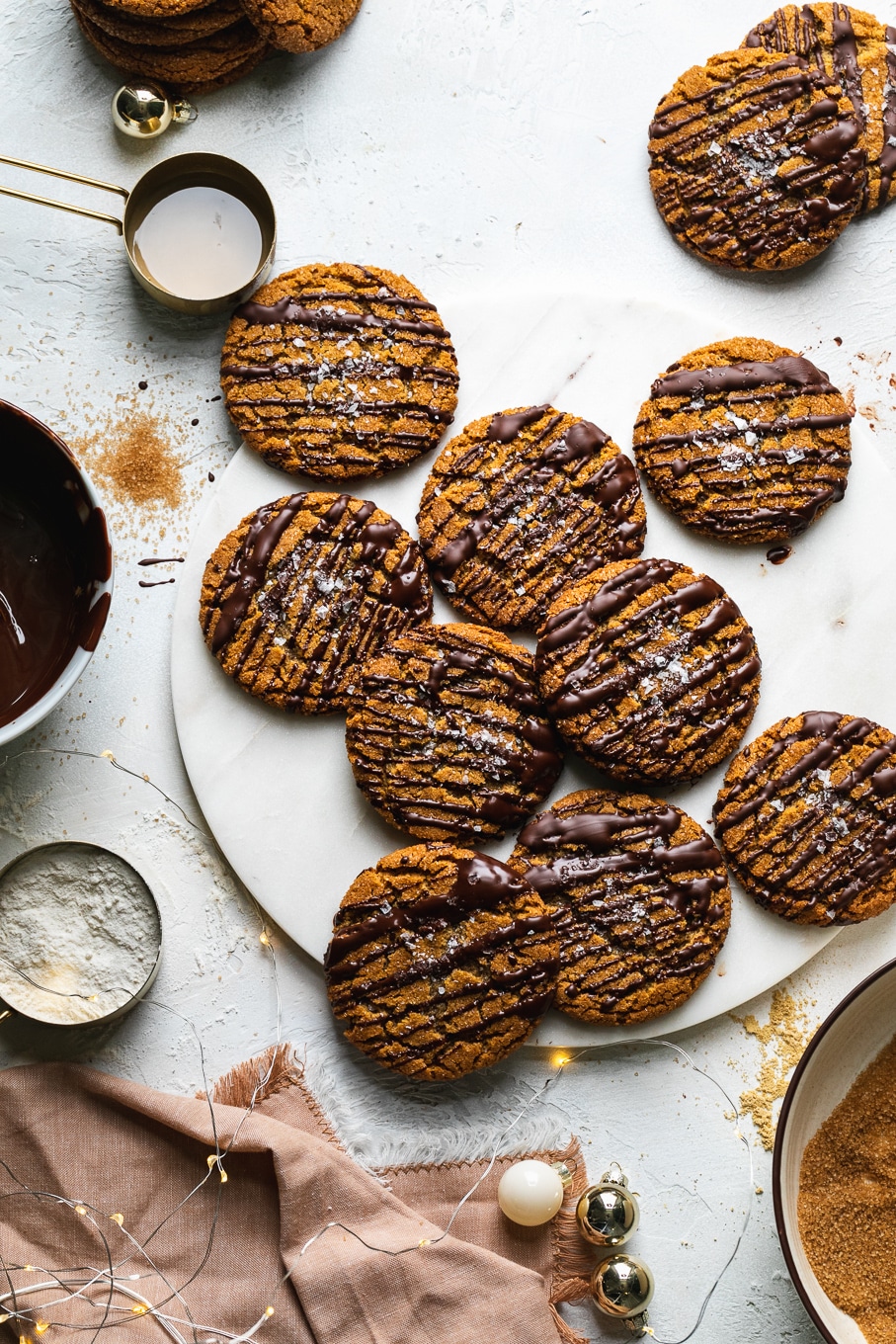 Overhead shot of gingersnap cookies on a marble board