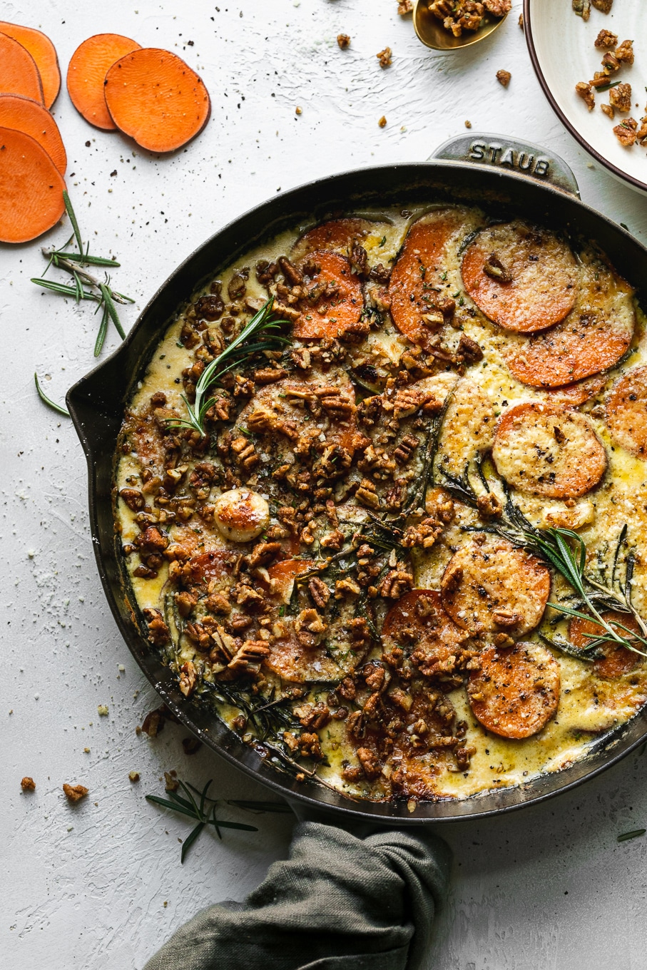 Overhead shot of sweet potato gratin after baking with rosemary pecan crunch on top