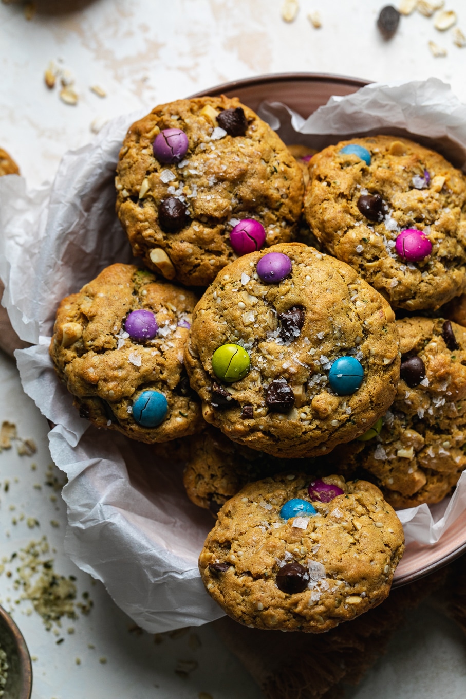 Overhead close up shot of a bowl of cookies filled with colorful candy coated chocolate pieces