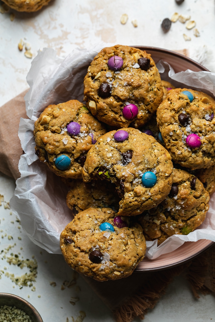 Close up shot of a bowl of monster cookies with a bite taken out on top