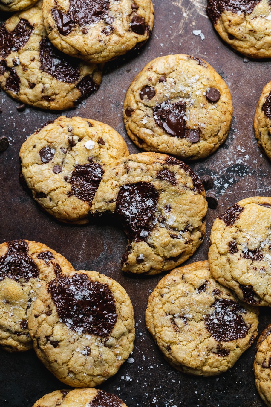 Overhead shot of chocolate chip cookies on a brown baking sheet