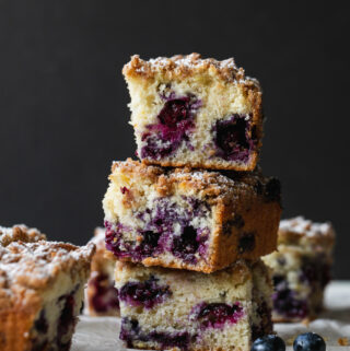 Straight-on shot of stacked pieces of blueberry buckle coffee cake